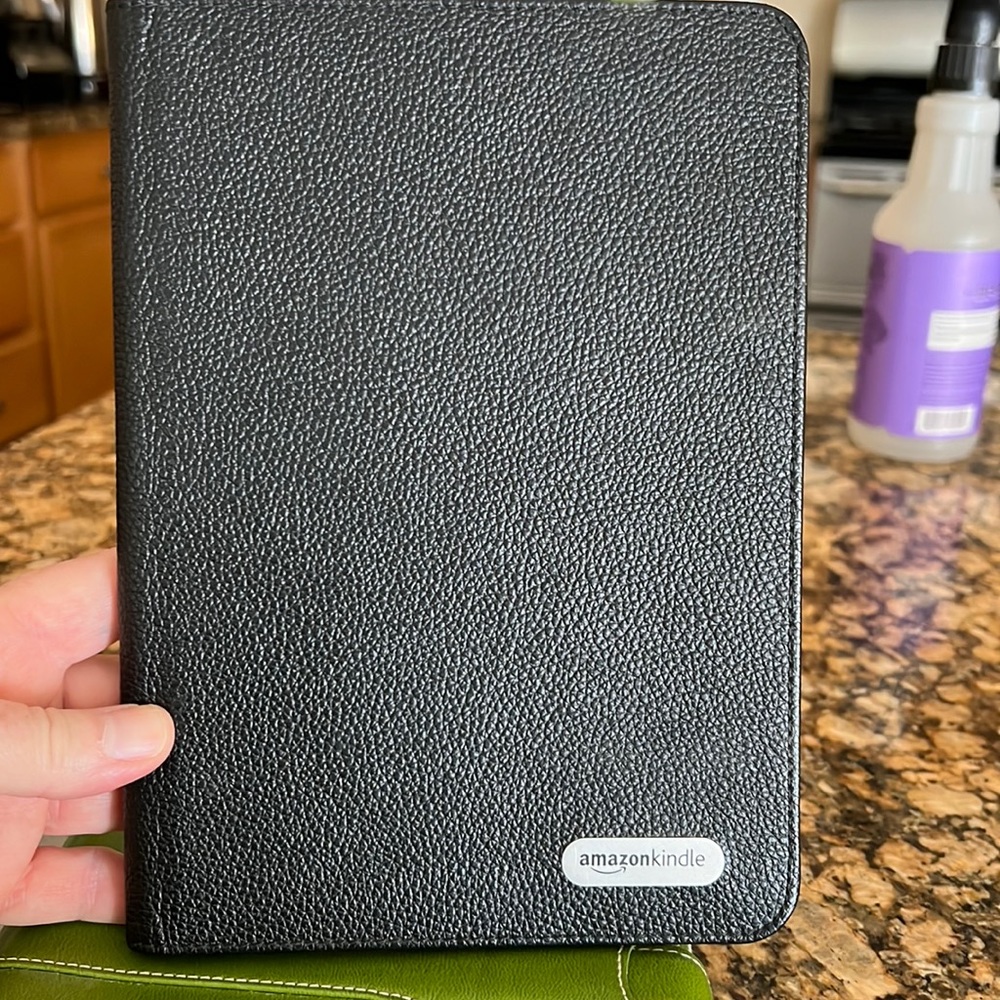 Kindle leather black cover. Binding 4” apart to attach to kindle
